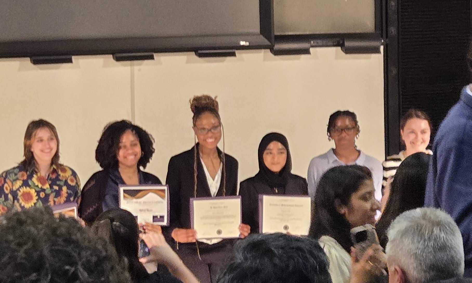Jessica winning the Osuna award for best talk.